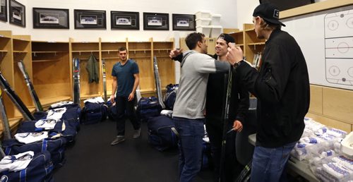 WAYNE GLOWACKI / WINNIPEG FREE PRESS    Manitoba Moose players from right, Axel Blomqvist, Scott Kosmachuk embraces Patrice Cormier and at far left is Brenden Kichton in their dressing room at the MTS Icleplex. With the season now over, players were cleaning out their lockers and meeting with coaches Monday. Tim Campbell story.  April 18  2016