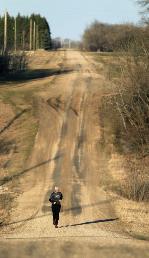 PHIL HOSSACK / WINNIPEG FREE PRESS One the eve of Manitoba's Provincial election Brian Pallister runs the gravel road at his family's farmstead near Edwin Mb SW of Portage La Prairie Monday evening. It's been a personal tradition for him to visit the farm run the section to prepare for election day. April 18, 2016 - APRIL 15, 2016
