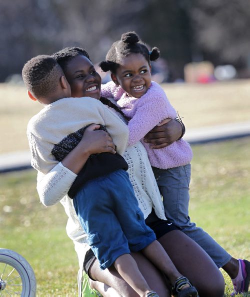 RUTH BONNEVILLE / WINNIPEG FREE PRESS

 FOUR-YEAR-OLD TWINS Josephine AND Joseph Tshibamba GIVE THEIR OLDER SISTER Ceclia A BIG HUG WHILE PLAYING  AT ASSINIBOINE PARK IN THE LATE AFTERNOON TUESDAY.  APRIL 19, 2016