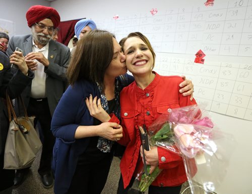 JASON HALSTEAD / WINNIPEG FREE PRESS  Liberal candidate for Burrows, Cindy Lamoureux (right), gets a kiss from her mom Cathy at her constituency headquarters on McPhillips Street after winning her seat on provincial election night on April 19, 2016.