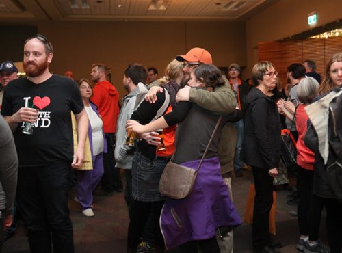 RUTH BONNEVILLE / WINNIPEG FREE PRESS

  NDP supporters share an embrace during  the provincial election coverage at the Convention Centre Tuesday evening.  APRIL 19, 2016