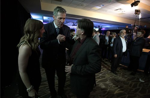 PHIL HOSSACK / WINNIPEG FREE PRESS Premier elect now, Brian Pallister makes a moment to congratulate MLA Ian Wishart post PC "party". Media aid Olivia Billson (right) directs.  See story. April 19, 2016