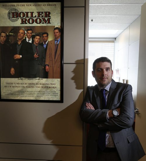 WAYNE GLOWACKI / WINNIPEG FREE PRESS        Jason Roy, a Manitoba Securities Commission senior investigator beside the poster for Boiler Room, a movie about investment fraud hanging outside his office.   He received a random call at home last week from one of these offshore investment scammers trying to get him to invest in binary options. He  played along and milked the guy (hes from Israel) for all the information he could. Now hes trying to get him charged. Murray McNeill  story April 21  2016