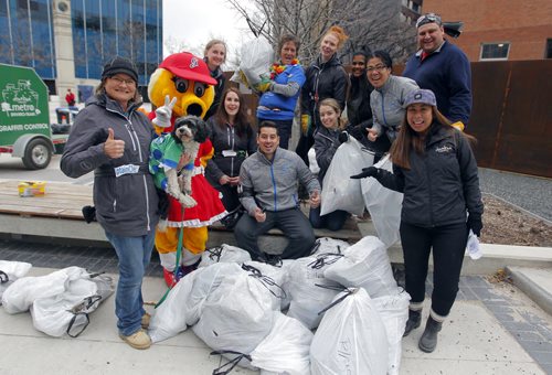 BORIS MINKEVICH / WINNIPEG FREE PRESS 11th annual Downtown Biz Earth Day Clean-up. Crews meet at Millenium Library Park after cleaning some downtown back allys. In this photo Tellpay employees with their trash picking up contributions pose for a photo. They call themselves "Super Clean Heros" and in total the company had 15 participants throughout the day help out. No all were there for this photo. They even had a team mascot dog named Riko with them. On the far right bottom is Downtown Biz events coordinator Rose Dominguez. April 22, 2016