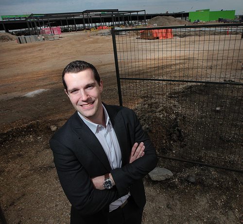 PHIL HOSSACK / WINNIPEG FREE PRESS Aaron DeGroot poses in front of the new "Outlet Collection Winnipeg" being built at the corner of Kenaston and Sterling Lyon Parkway. He's the VP of Stevenson Advisors Ltd. and talked to Murray McNeil. See his story.  April 22, 2016