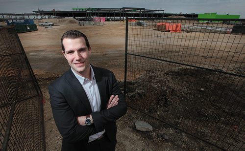 PHIL HOSSACK / WINNIPEG FREE PRESS Aaron DeGroot poses in front of the new "Outlet Collection Winnipeg" being built at the corner of Kenaston and Sterling Lyon Parkway. He's the VP of Stevenson Advisors Ltd. and talked to Murray McNeil. See his story.  April 22, 2016