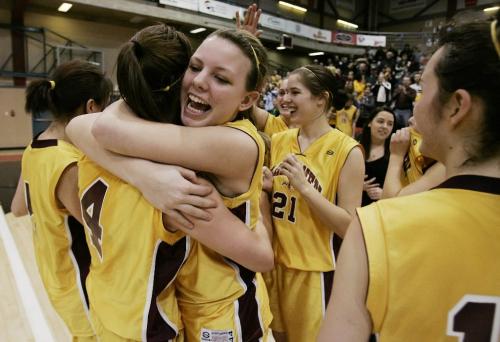 John Woods / Winnipeg Free Press / March 15/08- 080315  -  Erin Wedgewood (23) and Tia Coulter (4) of the Crocus Plains Plainsmen celebrate AAAA championship over the Sisler Spartans Saturday March 15, 2008.