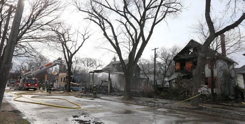 JASON HALSTEAD / WINNIPEG FREE PRESS  Firefighters work at the scene of a massive overnight blaze in Wolseley that started in an under-construction condominium building and spread to two neighbouring homes near the corner of Westminster Avenue and Maryland Street on April 23,  2016. (See Social Page)
