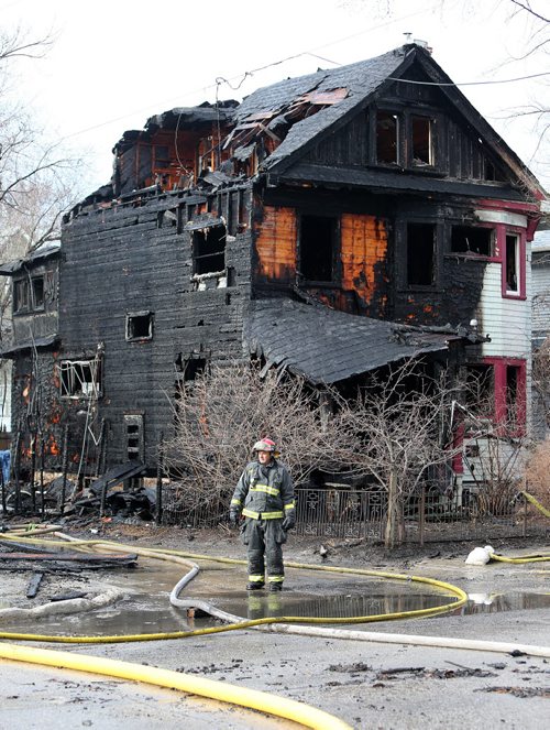 JASON HALSTEAD / WINNIPEG FREE PRESS  Firefighters work at the scene of a massive overnight blaze in Wolseley that started in an under-construction condominium building and spread to two neighbouring homes near the corner of Westminster Avenue and Maryland Street on April 23,  2016. (See Social Page)
