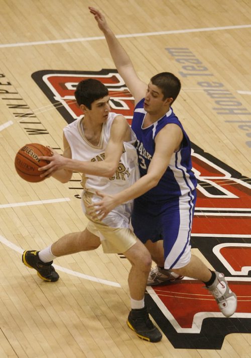 John Woods / Winnipeg Free Press / March 15/08- 080315  -  Marco Milosevic (16) of the Garden City Fighting Gophers finds himself under pressure from Oak Park Raiders Kerry Hosko (23)in the  AAAA championship at the U of Winnipeg Saturday March 15, 2008.