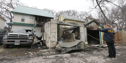 JASON HALSTEAD / WINNIPEG FREE PRESS  Members of the Winnipeg Police Service Arson Unit investigate a fire that hit two garages and two two vehicles in the 100 block of Chestnut Street in Wolseley on April 23, 2016. The vehicles and contents of the garage were all extensively damaged. There were no injuries and the cost of damages is unknown.