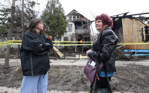 JASON HALSTEAD / WINNIPEG FREE PRESS  Neda Procner (left) and Linda Walker look at Procners house on Maryland Street in Wolseley that was destroyed by fire on April 23, 2016.