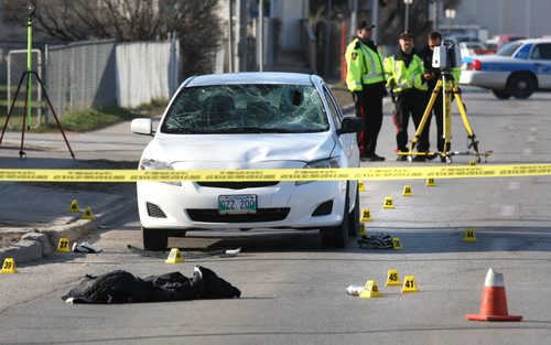 WAYNE GLOWACKI / WINNIPEG FREE PRESS     Winnipeg Police officers document the scene Tuesday morning on Keewatin St. near Pacific Ave. West after a pedestrian was struck by a car Monday evening. The incident has has closed the north bound lanes of Keewatin St.    April 26 2016