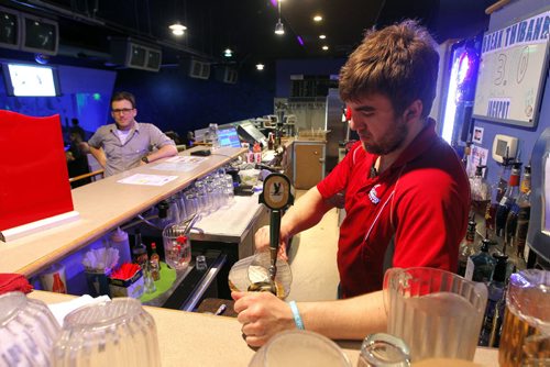 BORIS MINKEVICH / WINNIPEG FREE PRESS Sunday This City column on Academy Uptown Lanes. Twenty years ago, bowling was on a downswing - Academy was close to shutting down - when Todd Britton and his dad decided as a last-ditch effort to introduce glow bowling - a gimmick they heard about at a Las Vegas trade show. Worker Colton Farago pours a pitcher of beer. April 22, 2016