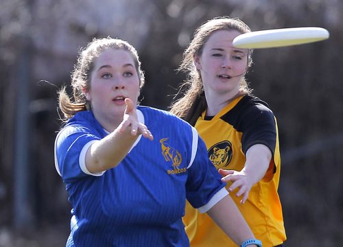 BORIS MINKEVICH / WINNIPEG FREE PRESS J. H. Bruns Bronco (blue) Rachel Treffner battles for the disc with a Windsor Park Royals player in Highschool mixed Ultimate play at Shamrock Park in Southdale. This is the first game for south Winnipeg teams. Broncos lost 8-13 to the Royals. April 26, 2016