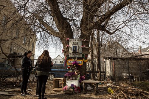 MIKE DEAL / WINNIPEG FREE PRESS Friends and family gather around a makeshift memorial for Simone Sanderson during a news conference in the vacant lot at Burrows and Main Street where Simone's body was found. 160427 - Wednesday, April 27, 2016