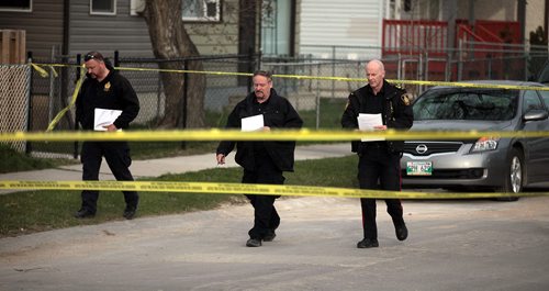 PHIL HOSSACK / WINNIPEG FREE PRESS Forensic officers walk the scene along Alexander ave Wednesday evening near where a man was stabbed Wednesday afternoon. See Alex Paul's story. April 27, 2016
