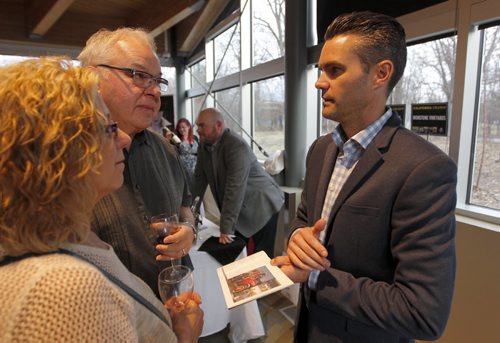 BORIS MINKEVICH / WINNIPEG FREE PRESS California Wine Festival at Assiniboine Park's Qualico Family Centre. California winery owner Joseph C. Lange, right,  of LangeTwins family winery and Vineyards sells his win, right, e to some wine lovers attending the event. April 27, 2016