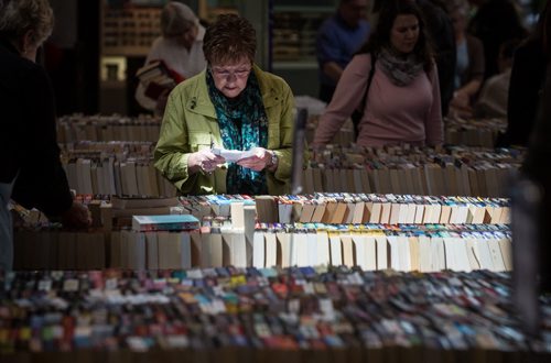 MIKE DEAL / WINNIPEG FREE PRESS Dianna Henzel (green jacket) browses through books at the Children's Hospital Book Market at St. Vital Shopping Centre which will be running until the afternoon of Saturday, April 30th.  160428 - Thursday, April 28, 2016