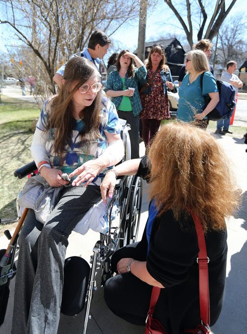 JASON HALSTEAD / WINNIPEG FREE PRESS  Helen Procner, who was pulled out of a fire in her Maryland Street home on April 23 with sister Neda Procner, speaks to Anne Fountain at a barbecue held for the two at Westminster United Church in Wolseley on April 30, 2016.