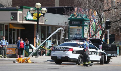 JASON HALSTEAD / WINNIPEG FREE PRESS  Emergency pesonnel work at the scene of a two-vehicle motor vehicle collision on April 30, 2016, at the intersection of River Avenue and Osborne Street. The truck involved in the MVC knocked over a traffic light.