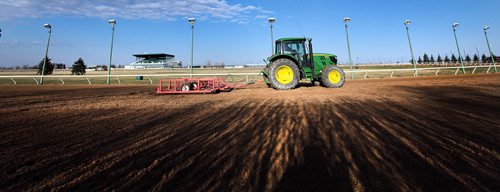 PHIL HOSSACK / WINNIPEG FREE PRESS Glen Simcoe and his John Deere groom the  six and a half furlong (3/4 mile) main track at Assiniboia Downs Monday. The track's Opening Day first day's Post Time is Sunday at 730 pm. May 2, 2016