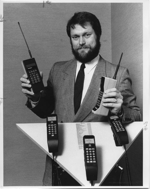 WINNIPEG FREE PRESS FILES MTS Cellular General Manager Pat Newbound demonstrates a few of the many models of cellular telephones being offered by Winnipeg dealers in anticipation of cellular phone service coming to Winnipeg on May 7, 1988.