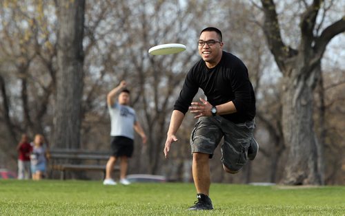 JASON HALSTEAD / WINNIPEG FREE PRESS  James Gomez chases the Frisbee thrown by his friend Deril Carranza as they enjoyed the warm evening on May 2, 2016, at Assiniboine Park. (For standup photo)