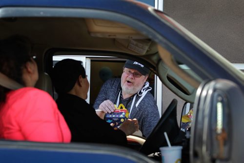 RUTH BONNEVILLE / WINNIPEG FREE PRESS    Free Press humour columnist Doug Speirs, serves up Happy Meals and Big Mac's to customers through the Drive-thru window at  the McDonalds at 1301 McPhillips St. Wednesday over the lunch hour for McHappy Day's, an annual fundraiser that  raises money for Ronald McDonald House.    May 04, , 2016