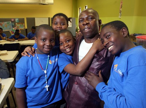 WAYNE GLOWACKI / WINNIPEG FREE PRESS  Mengi Mbekalo with St Aidans Christian School students from left, Epitas Ngendaruma, 11, Gervas Kezimana, 12, Levis Ndayikeza,14, and in back is Christina Dusabimana, 14.   Mengi, a recent refugee arrival who was touring this school with his kids when these children  he taught at a refugee camp in Tanzania a long time ago - recognized him.  Carol Sanders story.     May 4  2016