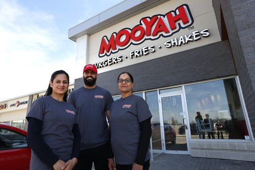 WAYNE GLOWACKI / WINNIPEG FREE PRESS    From left, Rubina Dhillon with her brother Sim Dhillon and mother Pim Dhillon at their Mooyah restaurant on Kenaston Boulevard in the Lindenridge Shopping Centre. Murray McNeill story.     May 5  2016