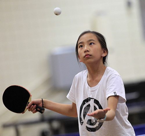PHIL HOSSACK / WINNIPEG FREE PRESS 12 yr old Anna Liu keeps an eye on the table tennis ball Thursday while practicing with the coach team members of Team Manitoba. See Scott Billeck story. May 5, 2016