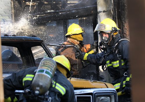 JOE BRYKSA / WINNIPEG FREE PRESS Fire crews were in the 100 block of Lisgar Ave in Point Douglas Friday morning extinguishing a garage and vehicle fire at the rear of a home  , May 06 , 2016.(Breaking News)