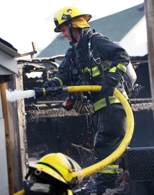 JOE BRYKSA / WINNIPEG FREE PRESS Fire crews were in the 100 block of Lisgar Ave in Point Douglas Friday morning extinguishing a garage and vehicle fire at the rear of a home  , May 06 , 2016.(Breaking News)