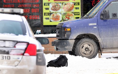 Winnipeg Police have tapped off a large portion of a parking lot at the Tyndall Market Mall on Keewatin-Inside the police tape is a armored car running near a entrance to the mall and a TD Canada Trust bank-A black duffle bag lies in the snow next to the armored car-See Bill Redekop storyNov 20, 2015   (JOE BRYKSA / WINNIPEG FREE PRESS)