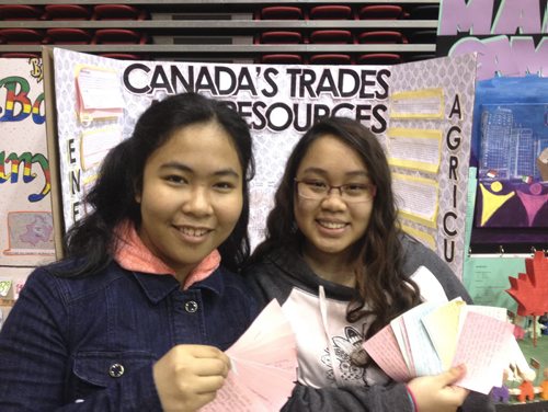 Aleli Godoy, 14, (left) and Shadina Caligagan, 15, both Grade 9 students at General Wolfe School, dished up facts on Canada's trade and resources at the Red River Heritage Fair. Doug Speirs photo, Winnipeg Free Press