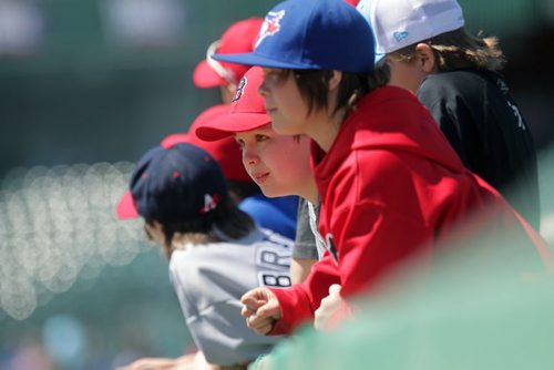 RUTH BONNEVILLE / WINNIPEG FREE PRESS  Members of the Bonivital Red Sox Pee Wee Baseball team watch the Goldeyes practice on the field at the opening day training camp Saturday at Shaw Field.    May 07, , 2016