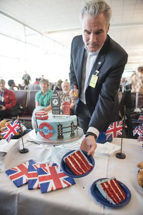 DAVID LIPNOWSKI / WINNIPEG FREE PRESS  Harry Taylor, Executive Vice President and Chief Financial Officer, WestJet, cuts cake prior to WestJets inaugural flight from Winnipeg to London from Winnipeg Richardson International Airport's gate 6 Saturday, May 7, 2016.