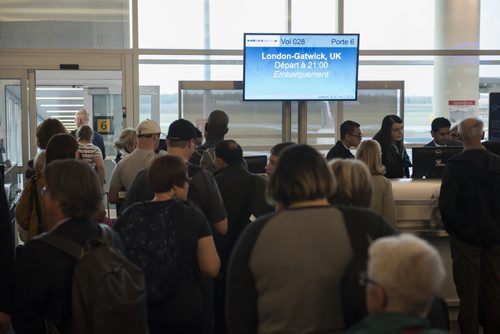DAVID LIPNOWSKI / WINNIPEG FREE PRESS  Passengers wait to board WestJets inaugural flight from Winnipeg to London from Winnipeg Richardson International Airport's gate 6 Saturday, May 7, 2016. She is traveling to Scotland to visit family.
