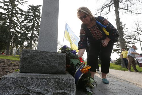 JOHN WOODS / WINNIPEG FREE PRESS Nadia Zeleniuk tend to a wreath as members from the Ukrainian, Jewish, Russian-speaking and Polish communities gather in Vimy Ridge Park for a day of remembrance and reconciliation for those tho died in World War Two, Sunday, May 8, 2016.