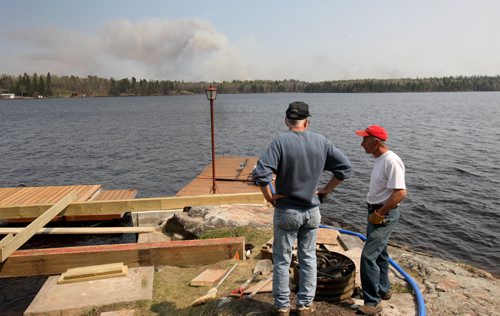 JOE BRYKSA / WINNIPEG FREE PRESS Grant Floren, left, and Howard Manchulenko watch wildfire fire burning from Caddy Lake   , May 09 , 2016.(Bill Redekop story)
