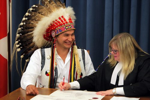 BORIS MINKEVICH / WINNIPEG FREE PRESS NDP MLA oath taking ceremony at the Manitoba Legislature room 200. Wabanakwut (Wab) Kinew gets signed into the job. Clerk of the Legislative assembly Patricia Chaychuk, right, helped out. May 9, 2016