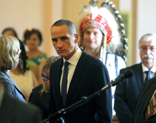 BORIS MINKEVICH / WINNIPEG FREE PRESS NDP MLA oath taking ceremony at the Manitoba Legislature room 200. Kevin Chief with Wabanakwut (Wab) Kinew behind him with head dress. May 9, 2016