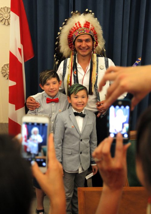 BORIS MINKEVICH / WINNIPEG FREE PRESS NDP MLA oath taking ceremony at the Manitoba Legislature room 200. Wabanakwut (Wab) Kinew gets his photo taken with his boys Dominik, 11, and Bezh, 8. May 9, 2016