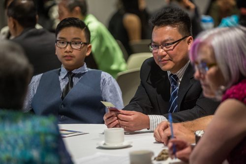 MIKE DEAL / WINNIPEG FREE PRESS Thai Nguyen (right) and his son Thai (left), 12, during a roundtable discussion put together by the Institute for Canadian Citizenship for the people who were about to become new Canadians at the Canadian Museum for Human Rights Monday afternoon. 160509 - Monday, May 09, 2016