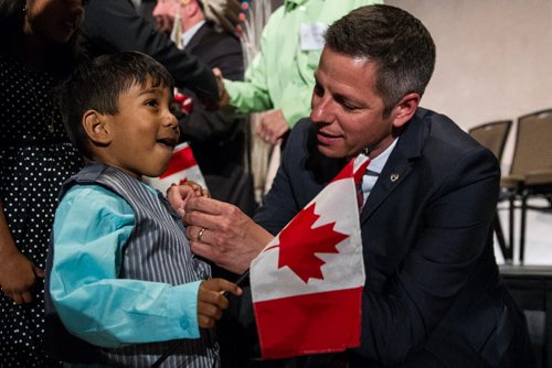 MIKE DEAL / WINNIPEG FREE PRESS Winnipeg Mayor Brian Bowman took a pin off his suit and pinned it to Inure Attanayaka, 3, after the citizenship ceremony at the Canadian Museum for Human Rights Monday afternoon. 160509 - Monday, May 09, 2016