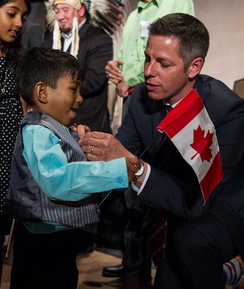 MIKE DEAL / WINNIPEG FREE PRESS Winnipeg Mayor Brian Bowman took a pin off his suit and pinned it to Inure Attanayaka, 3, after the citizenship ceremony at the Canadian Museum for Human Rights Monday afternoon. 160509 - Monday, May 09, 2016