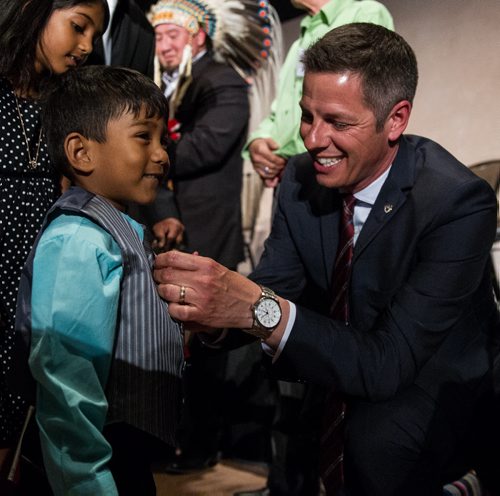 MIKE DEAL / WINNIPEG FREE PRESS Winnipeg Mayor Brian Bowman took a pin off his suit and pinned it to Inure Attanayaka, 3, after the citizenship ceremony at the Canadian Museum for Human Rights Monday afternoon. 160509 - Monday, May 09, 2016