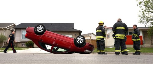 WAYNE GLOWACKI / WINNIPEG FREE PRESS  A male driver was uninjured after his car hit a parked vehicle on Templeton Ave. near McGregor St. Tuesday morning and flipped on it's roof.  A resident across the street of the crash thought she was hearing thunder outside.  May 10  2016