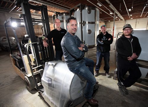 PHIL HOSSACK / WINNIPEG FREE PRESS -  Torque Brewing - Partner's in Craft Beer, (left to Right) Phil Bernardin, John Heim (front) Adam Olson and Matt Wolff take a break from assembling their new brewery to pose Tuesday afternoon. See Murray McNeill's story.  May 10, 2016